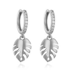 Detailed view of silver hoop earrings featuring a monstera leaf pendant and sparkling zircons