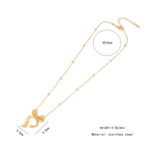Detail view of a gold stainless steel bow pendant necklace with dimension specifications