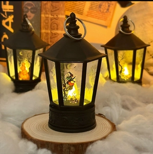 Detail of Halloween LED lanterns with wizard and pumpkin prints on rustic wooden bases