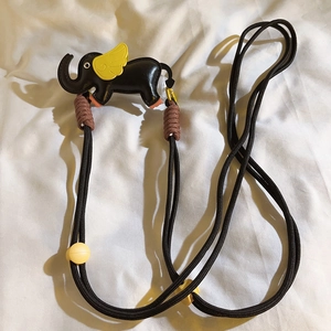 Detail of a cute elephant leather phone lanyard with woven strap and colorful beads