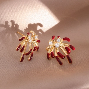 Detail of 18k gold plated firework studs with red enamel and sparkling zircons