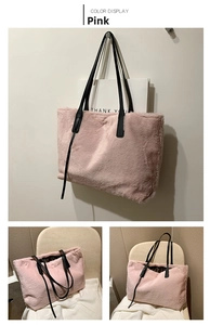 Detail of pink plush tote bag showing soft faux fur texture and black leather straps