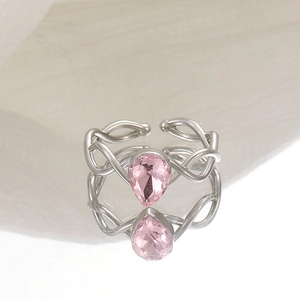 Detail shot of pear-shaped pink gemstone ring with woven adjustable silver band
