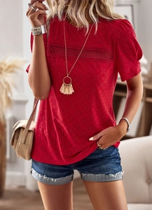 Detail of red crew neck top with lace hollow stitching and eyelet embroidery pattern