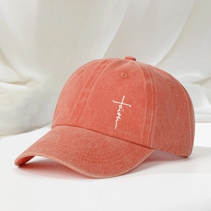 Detail showing white faith and cross embroidery on vintage washed cotton baseball cap