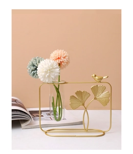 Detail of golden ginkgo leaf vase with bird sculpture and hydroponic test tube