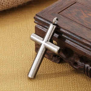 Vintage oxidized silver cross pendant for men made of durable stainless steel on wood