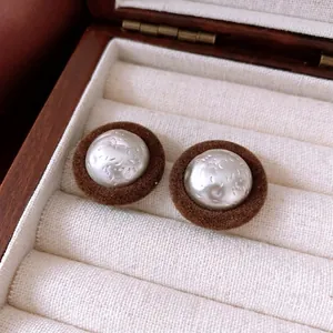 Retro round plush earrings featuring hammered silver metal domes and brown flocking detail