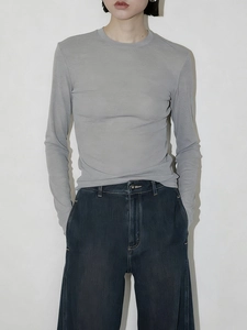 Detail of light grey slim fit long sleeve top showing ribbed texture and crew neck