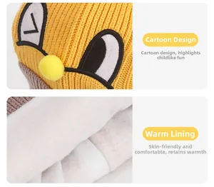 Detailed view of yellow knit hat featuring cartoon embroidery and soft warm fleece lining