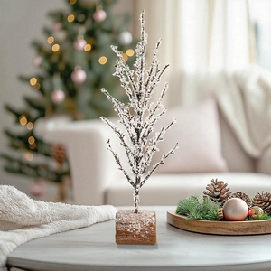Artificial pine Christmas tree with frosted branches and stable square wooden base