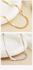 Detail showing polished gold and silver herringbone chains on minimalist background