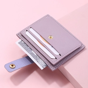 Detail of light purple leather card holder with card slots, cash pocket and metal snap button
