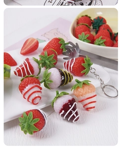 Close-up of realistic artificial strawberries with cream and chocolate glaze texture