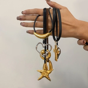 Starfish and moon pendants on black cord necklaces in gold and silver finish