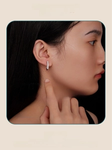 Close-up of S925 sterling silver U-shaped earrings with five round moissanite stones