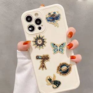 Detailed view of vintage gold galaxy stickers applied on a white smartphone case