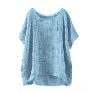 Detail of light blue linen blend top featuring a round neck and square chest pocket