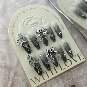 Handmade gray gradient ombre nails with glitter, metal butterflies, and rhinestones