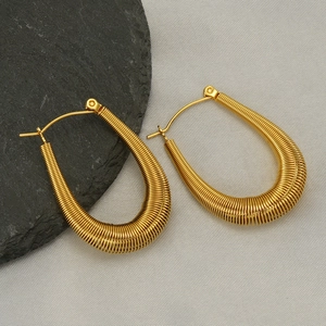 Golden U-shaped stainless steel earrings with textured wire wrap design on neutral background