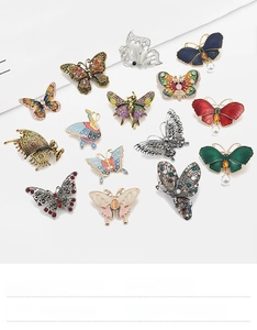 Macro detail of various alloy butterfly brooches with zircon inlay and enamel finish