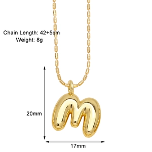 Macro shot of gold-plated puffy letter M pendant with chain size 42+5cm details