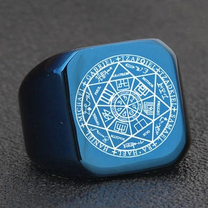 Macro shot of blue stainless steel ring with Archangel Michael and Gabriel engravings
