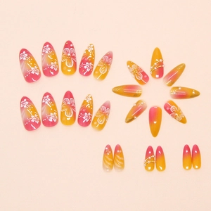 Close-up of gradient press-on nails with floral art and 3D pearl embellishments