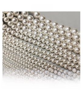 Detailed size comparison of polished white pearl beads for jewelry making and DIY projects