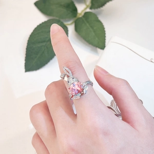 Close-up of a silver rabbit ring with a heart-shaped pink gemstone and pave accents