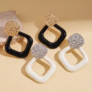 Geometric square earrings in hammered gold and silver metal with resin hoops