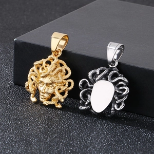 Detailed view of gold and silver Medusa pendants with a smooth engravable back surface