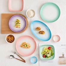 Detailed macro view of gradient pastel ceramic egg tray plates and tableware set