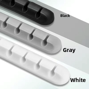 Detail of multi-slot silicone cable organizers in black, gray, and white colors