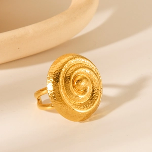 18K gold-plated stainless steel spiral ring with a hammered texture on warm background