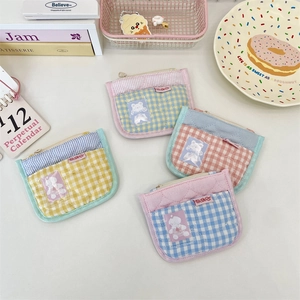 Detailed view of macaron quilted coin purses with cute bear patches and metal zippers