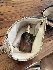 Overhead view of a floral canvas makeup bag showing spacious interior with cosmetics