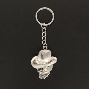 Vintage silver skull keychain with cowboy hat pendant made of polished metal