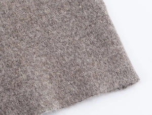 Detailed macro view of the soft grey knit fabric texture with fine wool fibers