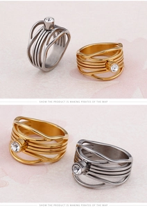 Detail of layered hollow fish-tail style titanium steel ring with round zircon inlay
