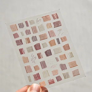 Macro detail of MS-662 nail stickers featuring brown earth-tone woven patterns and love text
