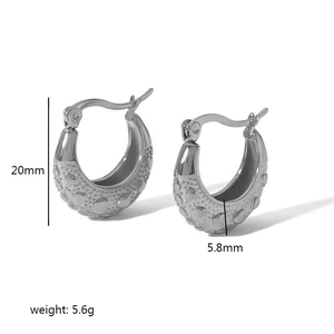 Detail view of silver C-shaped heart textured hoop earrings showing 20mm height dimensions