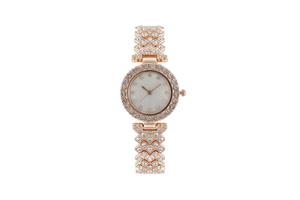 Detail of gold women's watch with crystal-encrusted bezel and mother-of-pearl dial