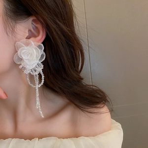 Detail shot of vintage lace flower earrings with elegant long crystal tassels for women