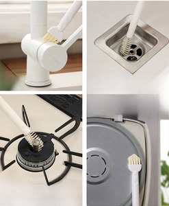 Detail of multi-functional gap cleaning brush used on faucet, sink and stove areas