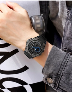 Close-up of SANDA black sports watch with dual display on a model in street style
