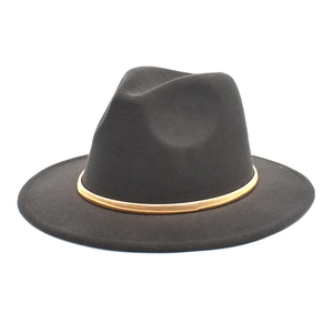 Detail of dark fedora hat featuring a smooth gold metallic decorative band on wool felt