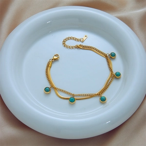 Double-layered gold titanium bracelet with snake chain and turquoise stone pendants