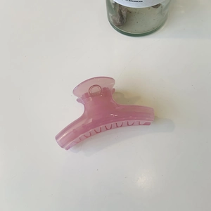Detail view of large pink translucent hair claw clip with smooth round non-slip teeth