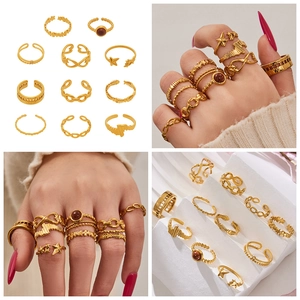 Detailed view of 11-piece gold geometric ring set with star and chain link designs